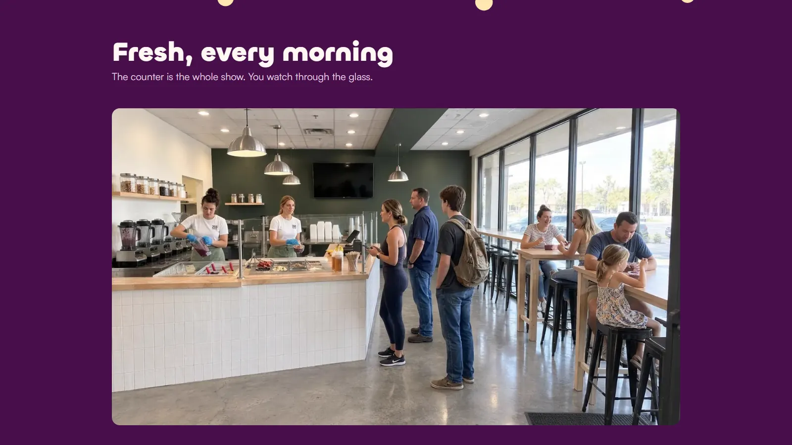 The 208 Acai shop: two staff building bowls at the counter, three customers in line and people eating at the window bar