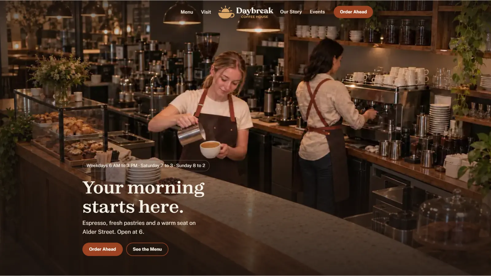 Daybreak Coffee House home page on a laptop: two baristas behind the counter under the headline Your morning starts here